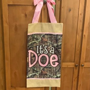 It’s a Doe Mossy Oak baby announcement door banner with pink ri…